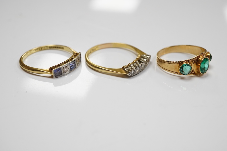 A group of three rings and a gold toothpick